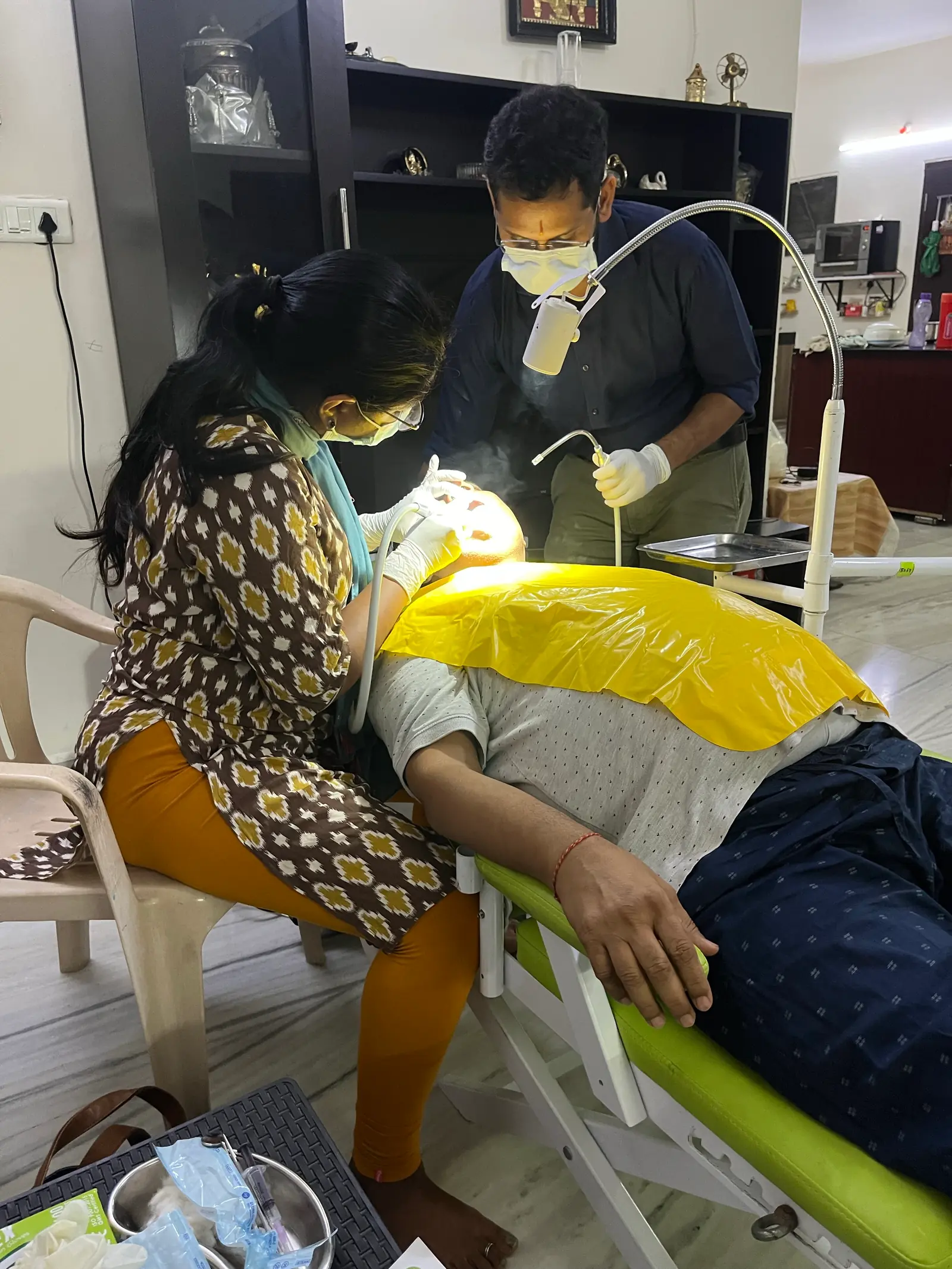 Prudentoe dentists performing a dental procedure during a home appointment in Hyderabad