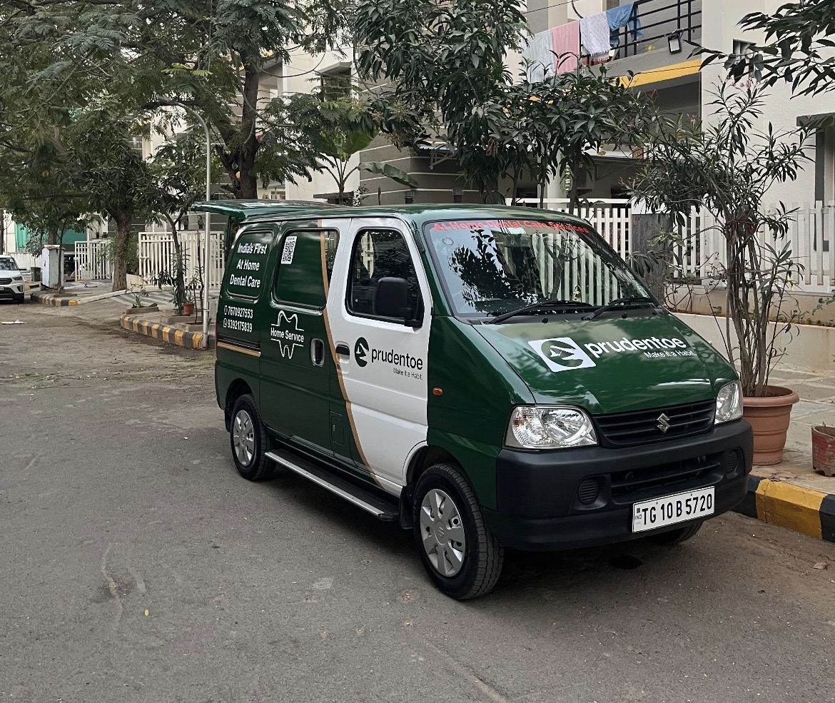 Prudentoe branded home dental care service van parked in a Hyderabad residential community