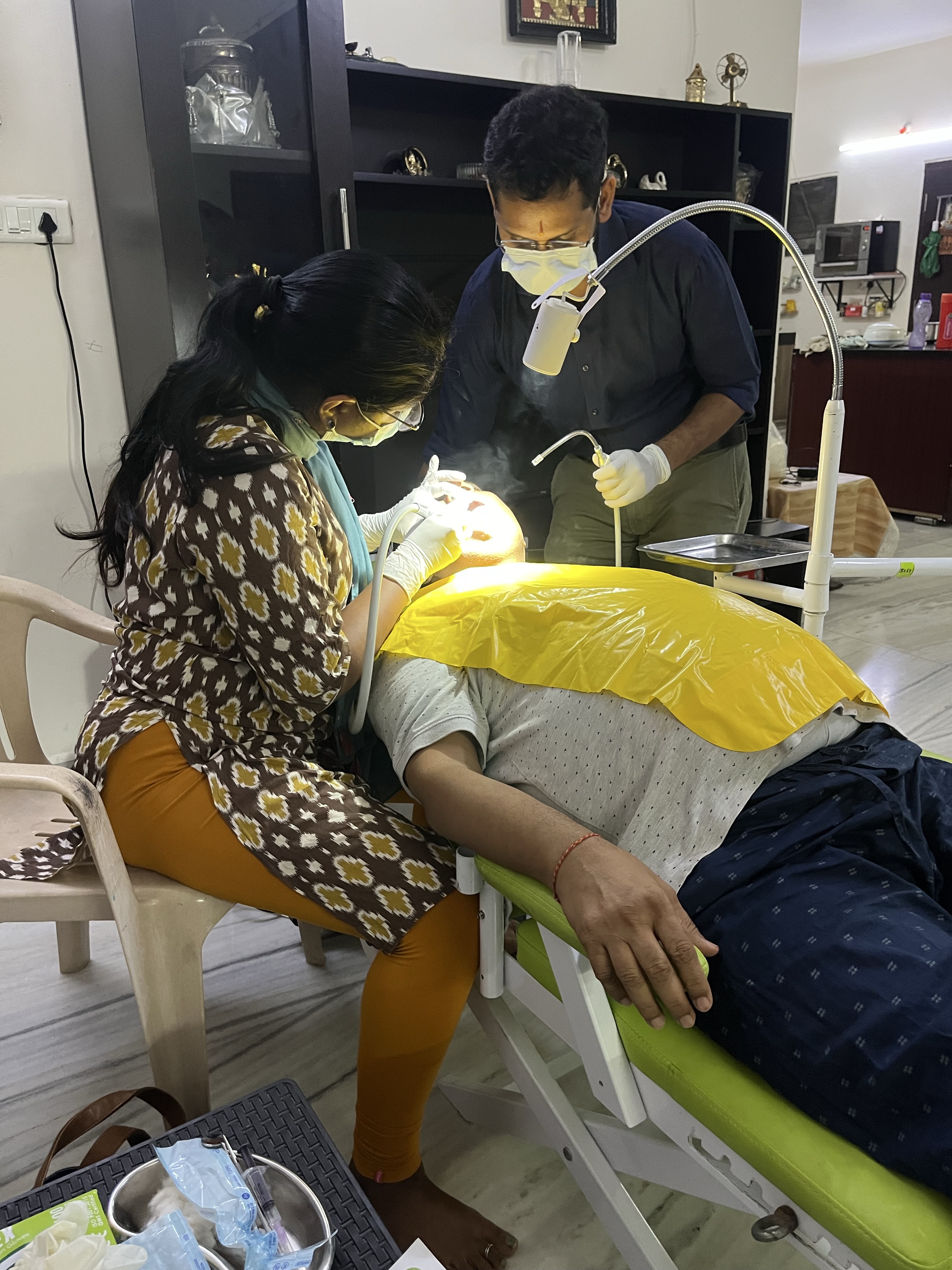 Prudentoe dentists performing a dental procedure during a home appointment in Hyderabad