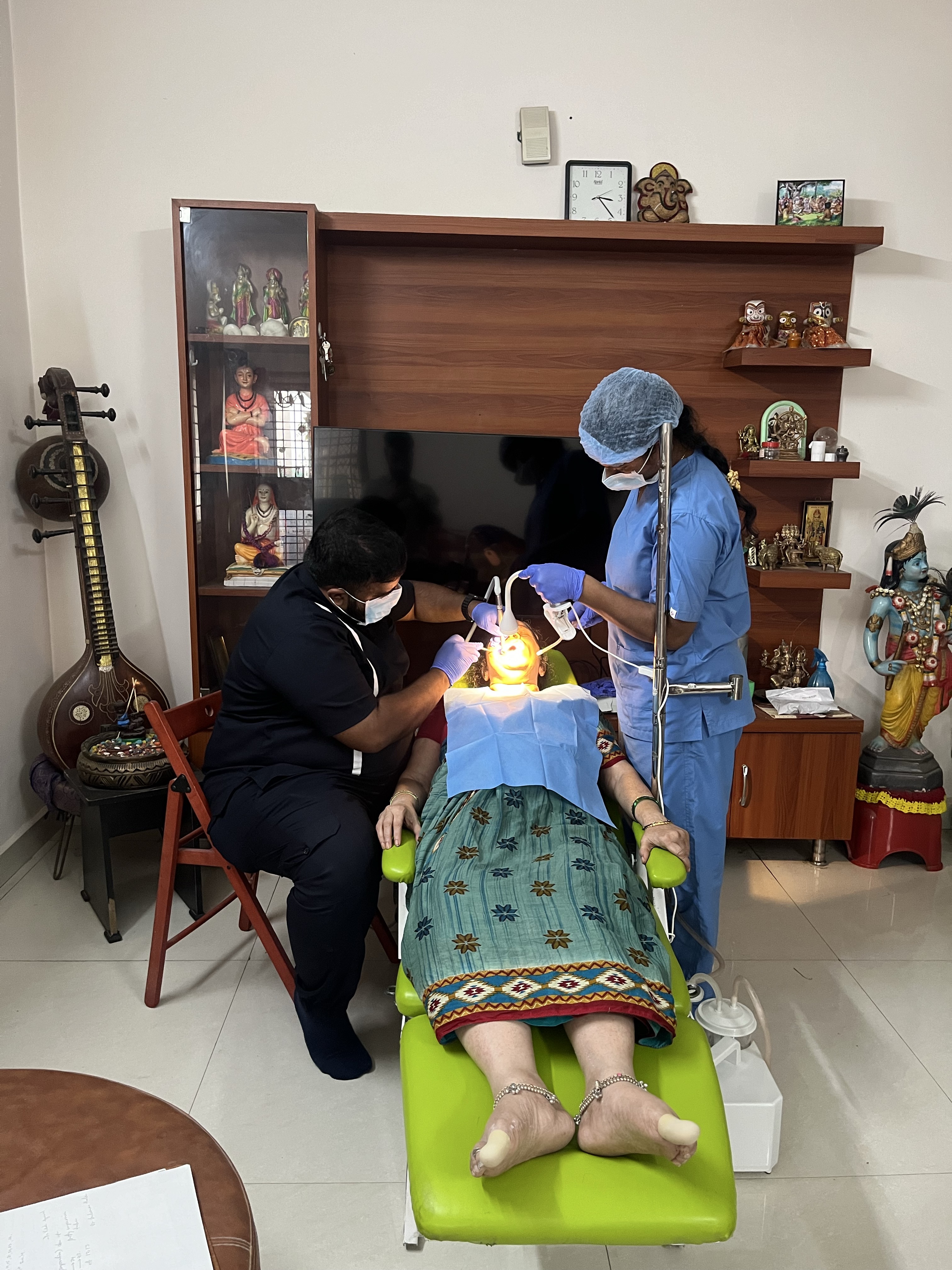 Prudentoe dentists providing gentle home dental care to an elderly patient in Hyderabad